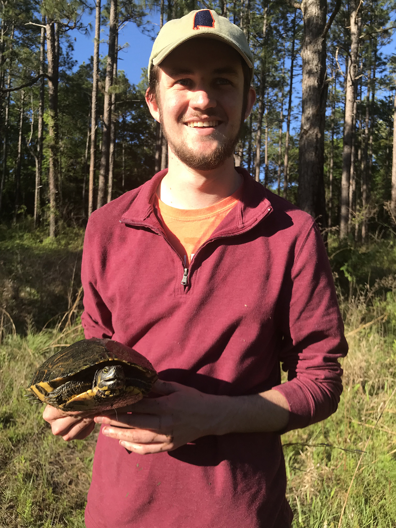 Ryan wearing a hat and holding a turtle